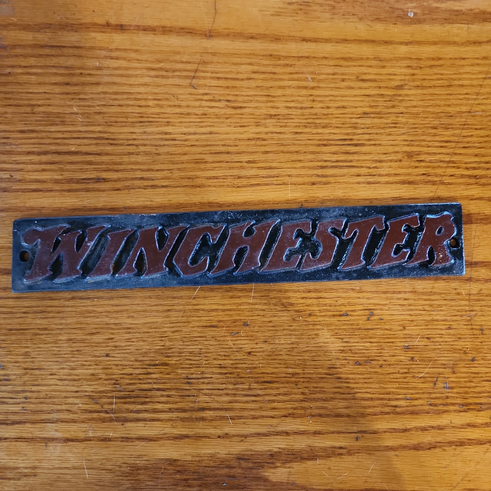 Winchester cast iron sign.-Jantiques LLC.