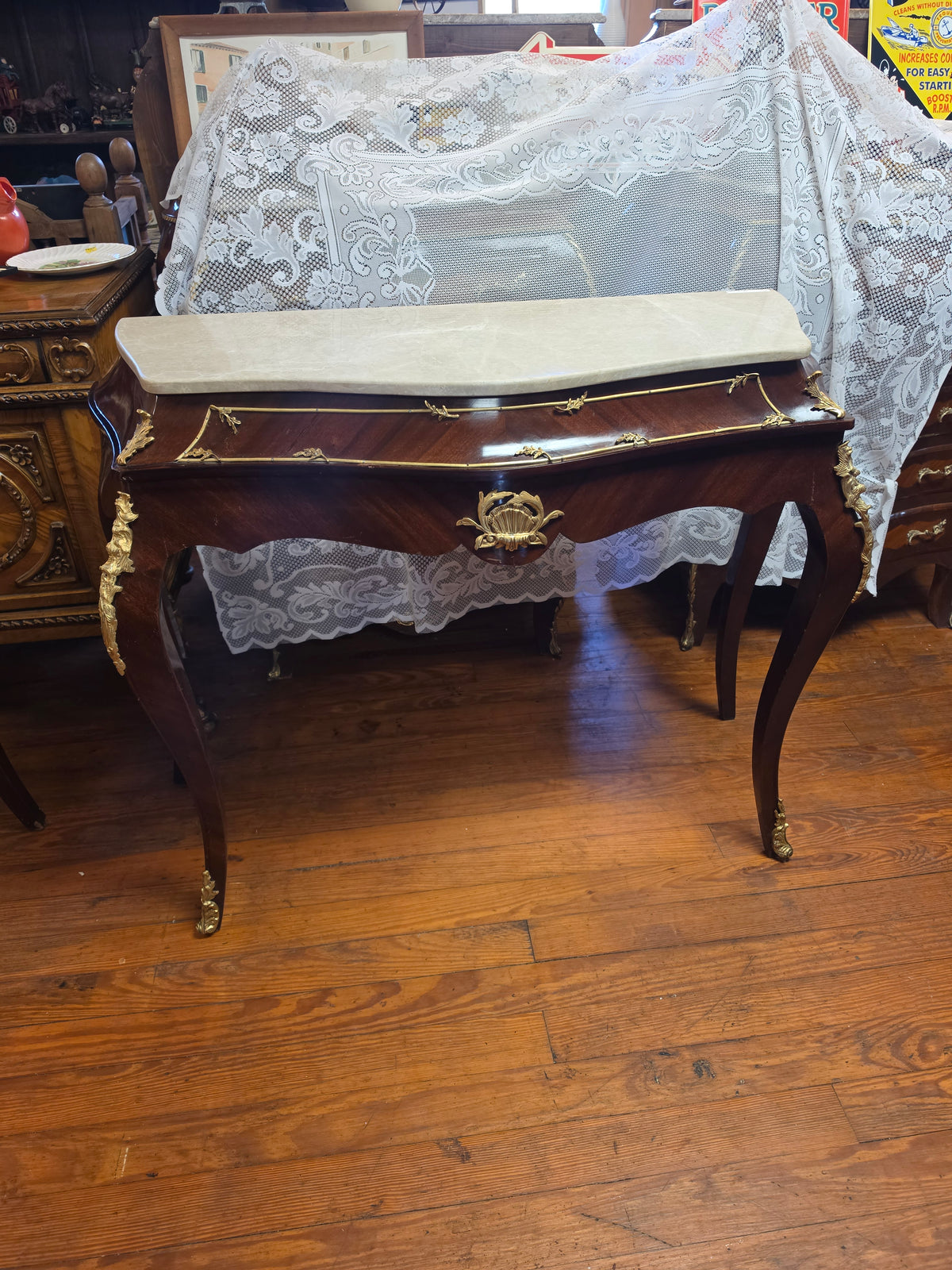 Console Table featuring a Shaped Cream Color Marble top