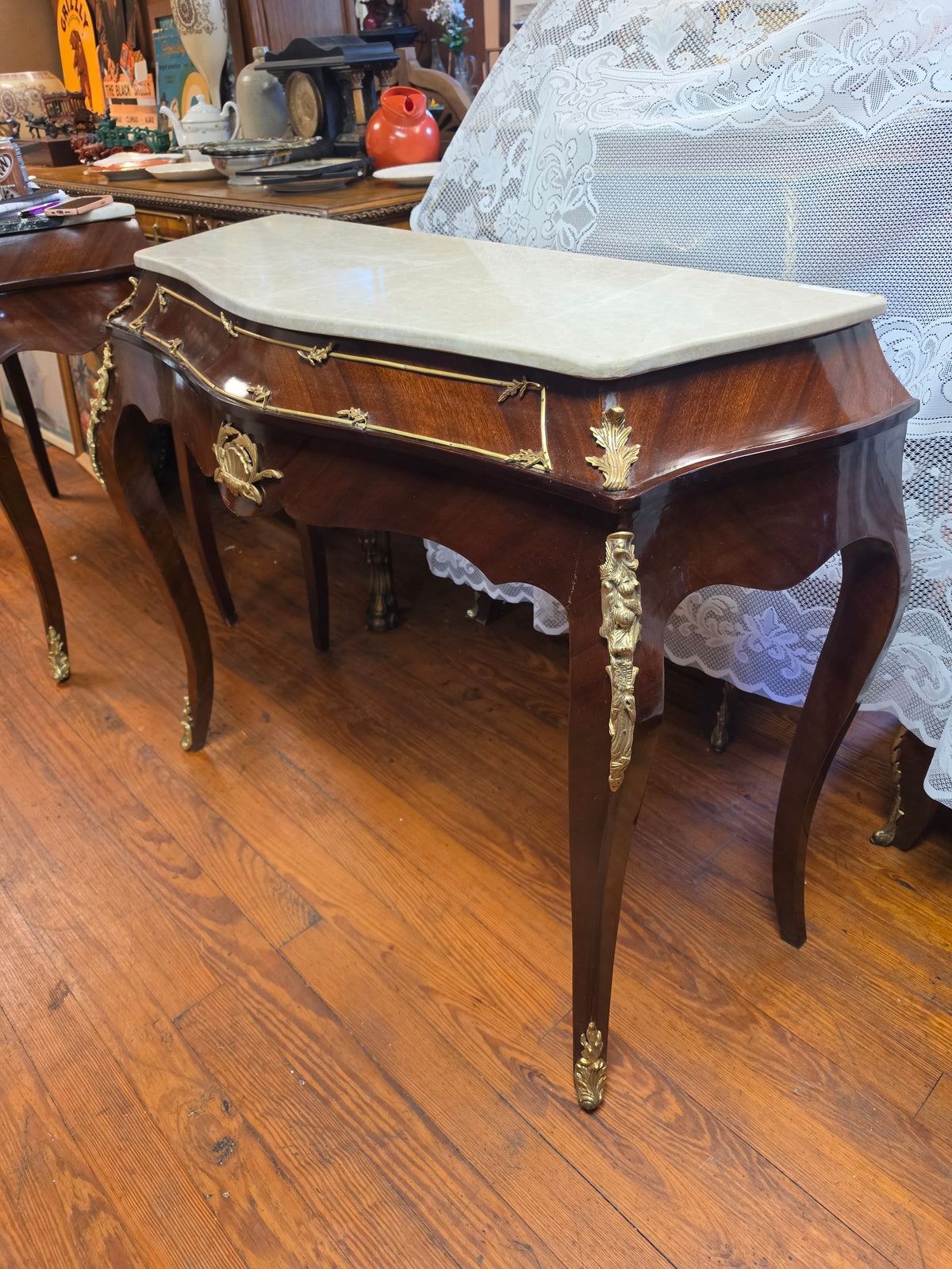 Console Table featuring a Shaped Cream Color Marble top