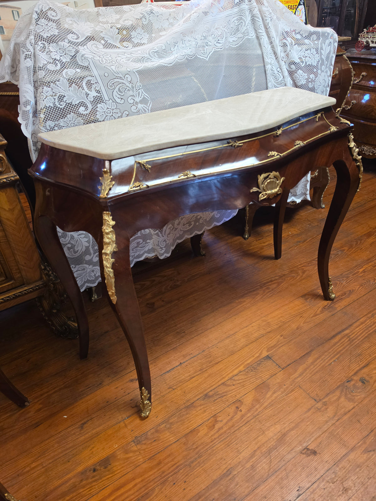 Console Table featuring a Shaped Cream Color Marble top