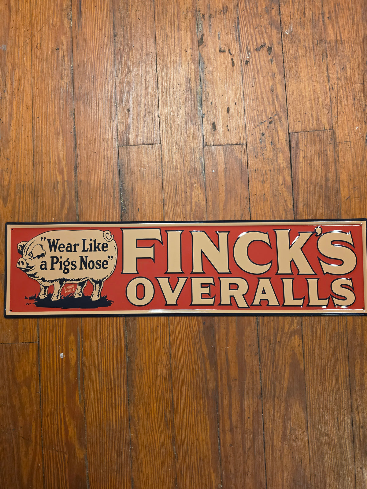 Finck's Overalls metal sign